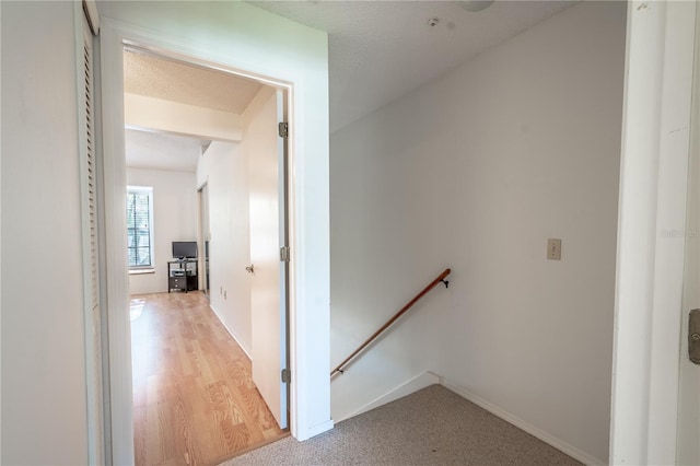 corridor featuring hardwood / wood-style flooring and a textured ceiling