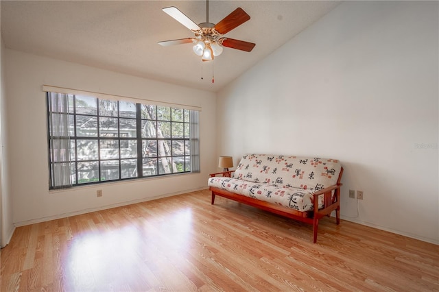 living area with light wood-type flooring, vaulted ceiling, and ceiling fan