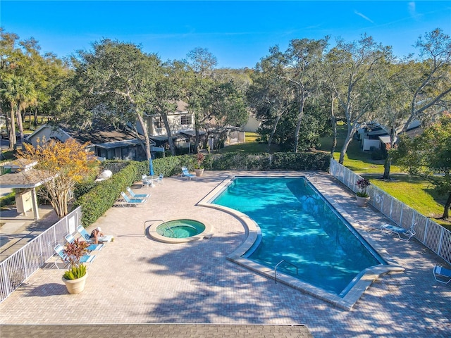 view of swimming pool with an in ground hot tub and a patio