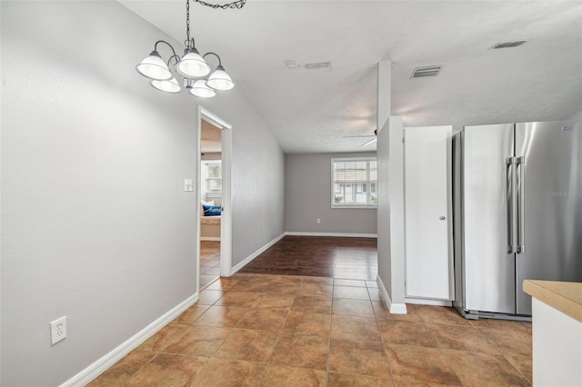 hallway featuring hardwood / wood-style flooring and a notable chandelier