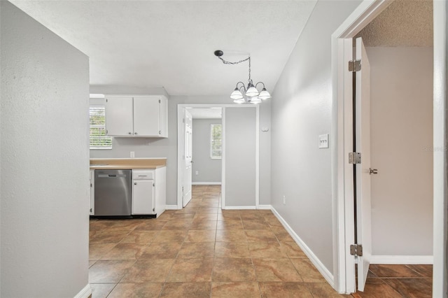 kitchen featuring dishwasher, a chandelier, a textured ceiling, decorative light fixtures, and white cabinets