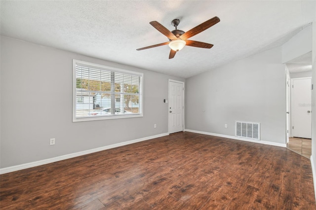 unfurnished room featuring a textured ceiling, ceiling fan, and dark wood-type flooring