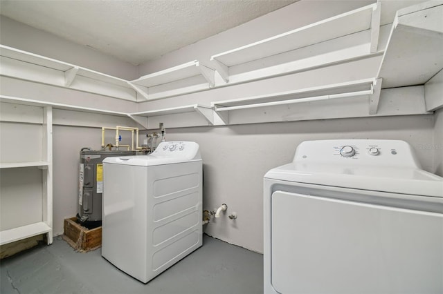 laundry area featuring washing machine and dryer and electric water heater