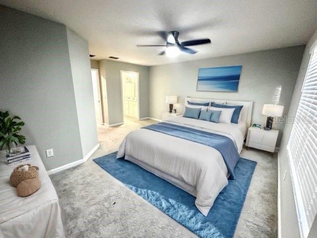 bedroom featuring a textured ceiling, carpet floors, and ceiling fan