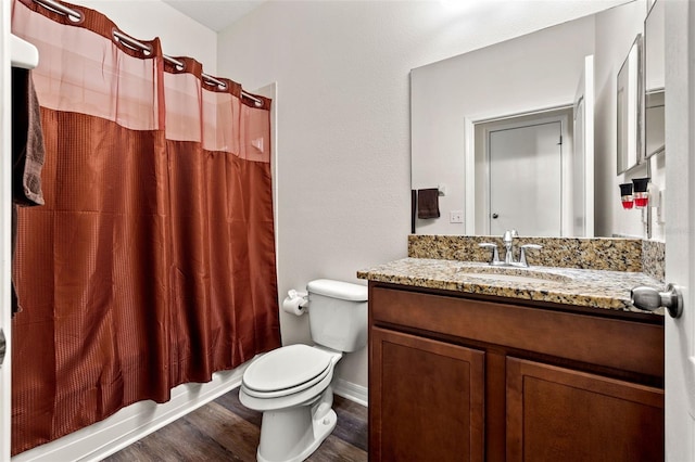 full bathroom with vanity, hardwood / wood-style floors, shower / bathtub combination with curtain, and toilet