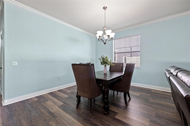 dining room with an inviting chandelier, ornamental molding, and dark hardwood / wood-style flooring