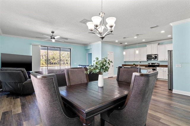 dining space with crown molding, dark hardwood / wood-style floors, ceiling fan with notable chandelier, and a textured ceiling