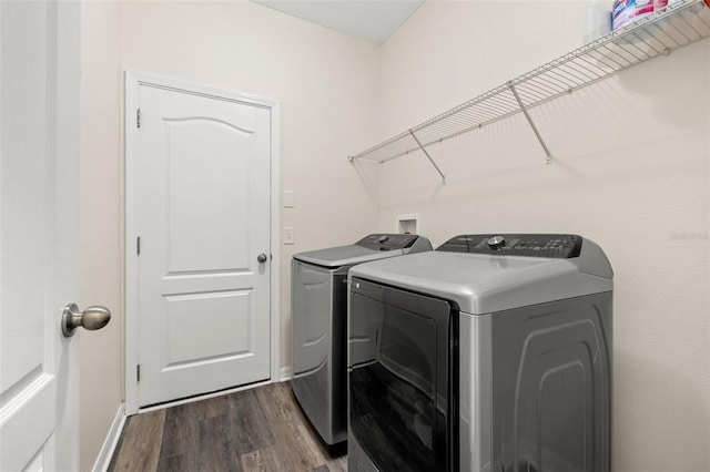 laundry area featuring separate washer and dryer and dark hardwood / wood-style flooring