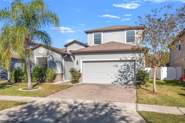 front of property featuring a garage and a front lawn