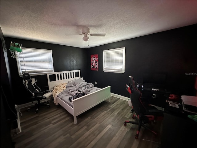 bedroom featuring ceiling fan, wood-type flooring, and a textured ceiling