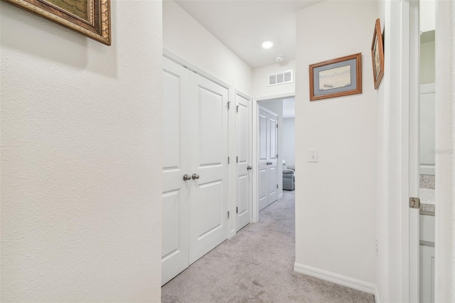 corridor with light colored carpet