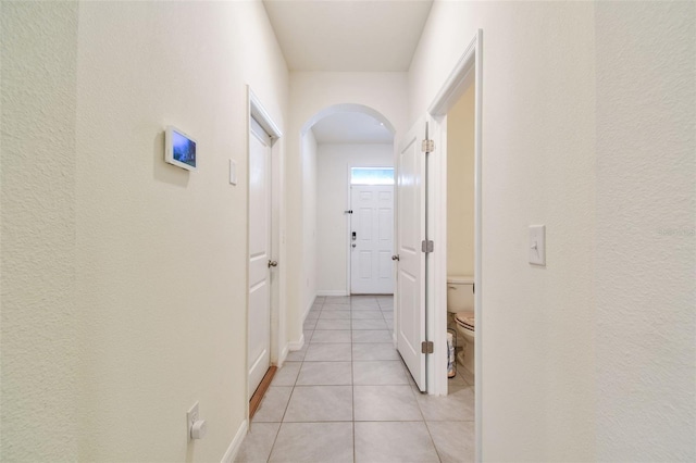 hall featuring light tile patterned floors