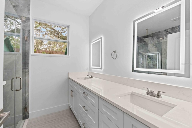 bathroom featuring wood-type flooring, vanity, and walk in shower