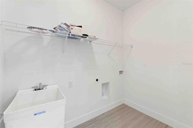 laundry area with electric dryer hookup, wood-type flooring, sink, and hookup for a washing machine