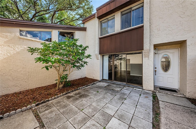 entrance to property featuring a patio