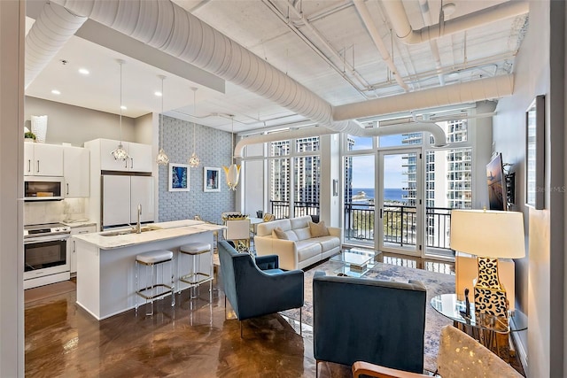 living room with floor to ceiling windows and sink