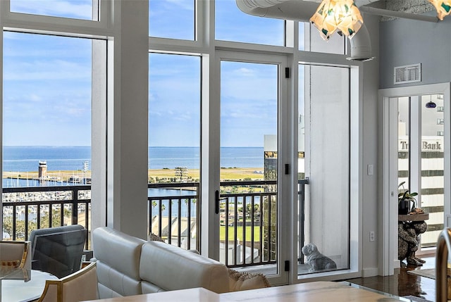 sunroom featuring plenty of natural light and a water view