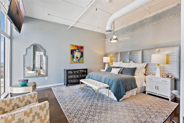 bedroom with a high ceiling and ceiling fan