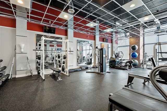 workout area with a towering ceiling