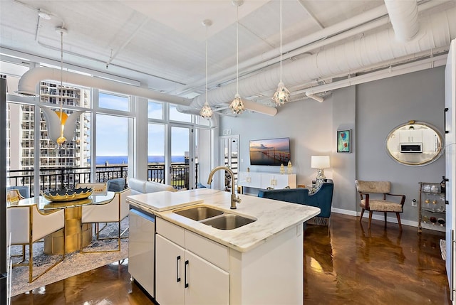 kitchen featuring dishwasher, sink, an island with sink, decorative light fixtures, and white cabinets