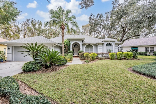 single story home featuring a front yard and a garage