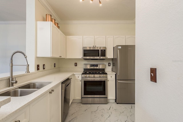 kitchen with appliances with stainless steel finishes, light stone counters, ornamental molding, sink, and white cabinetry