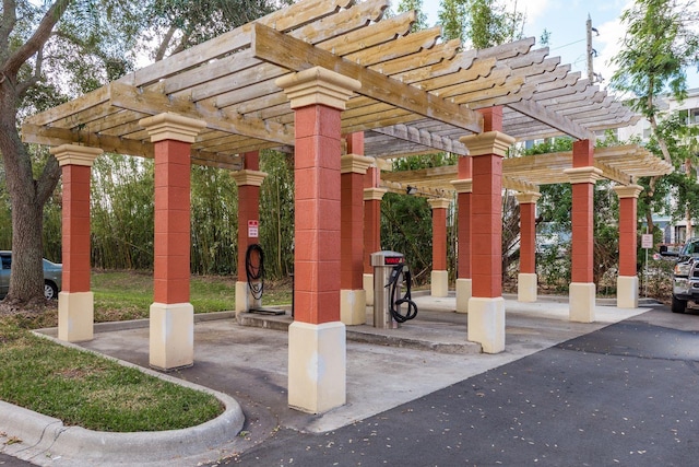 view of property's community with a pergola and a patio