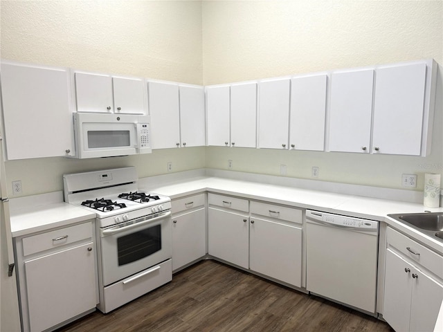 kitchen with light countertops, white appliances, and white cabinets