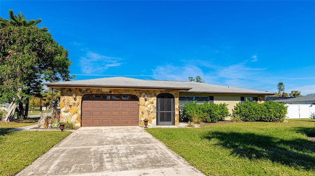 ranch-style house featuring a front yard and a garage