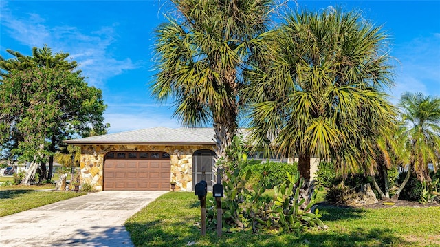 view of front of house featuring a front yard and a garage