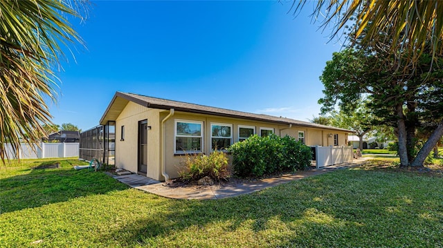 exterior space featuring a yard and a lanai