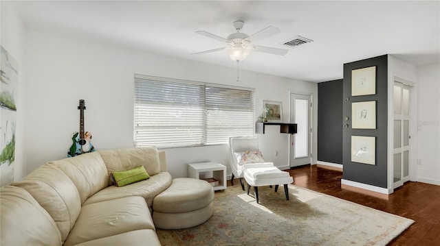 living room with ceiling fan and dark hardwood / wood-style floors