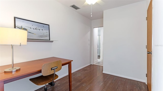 unfurnished office featuring dark wood-type flooring and ceiling fan