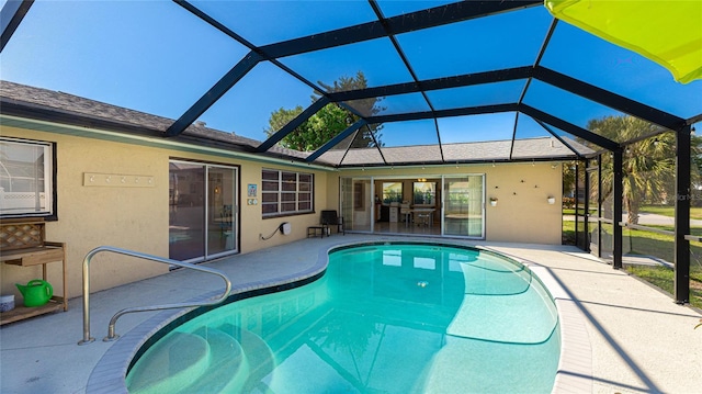 view of swimming pool featuring a lanai and a patio area