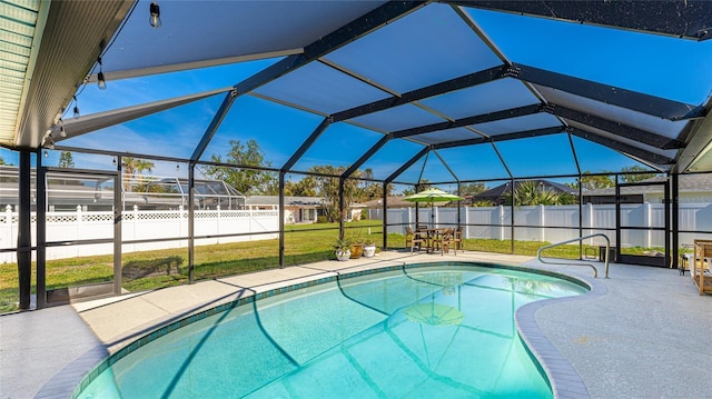 view of swimming pool featuring a lanai, a patio area, and a lawn