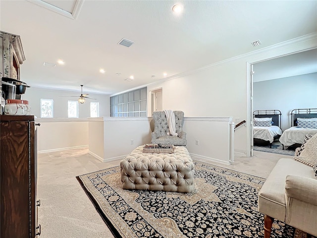 sitting room featuring ornamental molding and light colored carpet