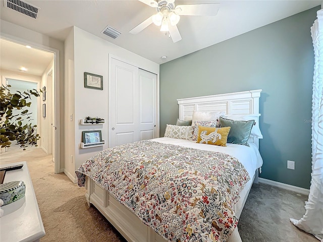 carpeted bedroom featuring a closet and ceiling fan