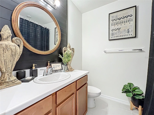 bathroom with tile patterned floors, toilet, and vanity