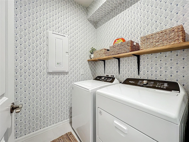 clothes washing area featuring tile patterned flooring and washer and clothes dryer