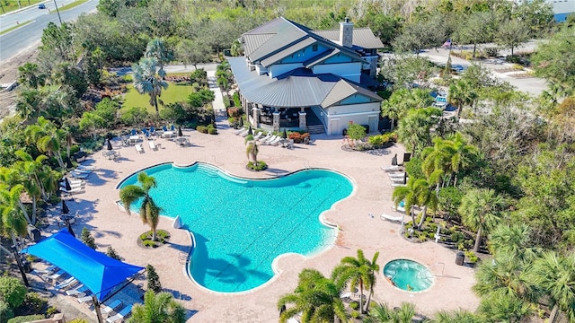 view of pool featuring a hot tub and a patio area