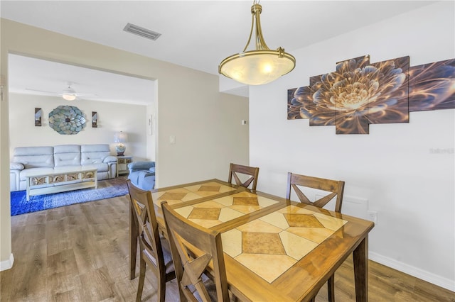 dining space featuring ceiling fan and hardwood / wood-style flooring