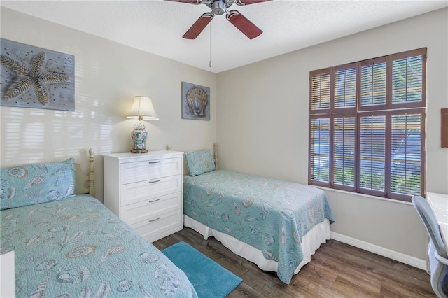 bedroom featuring a textured ceiling, dark hardwood / wood-style flooring, and ceiling fan