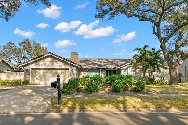 single story home featuring a front lawn and a garage