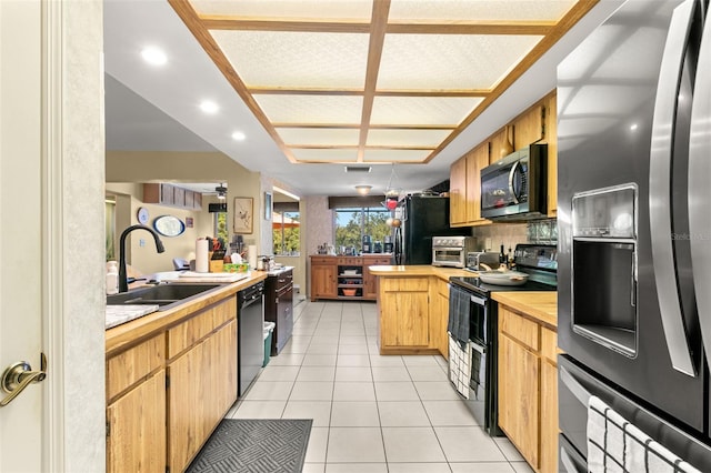 kitchen with decorative backsplash, light tile patterned floors, stainless steel appliances, and sink