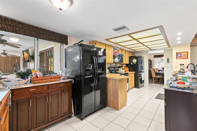 kitchen with black appliances, ceiling fan, light tile patterned flooring, and decorative light fixtures