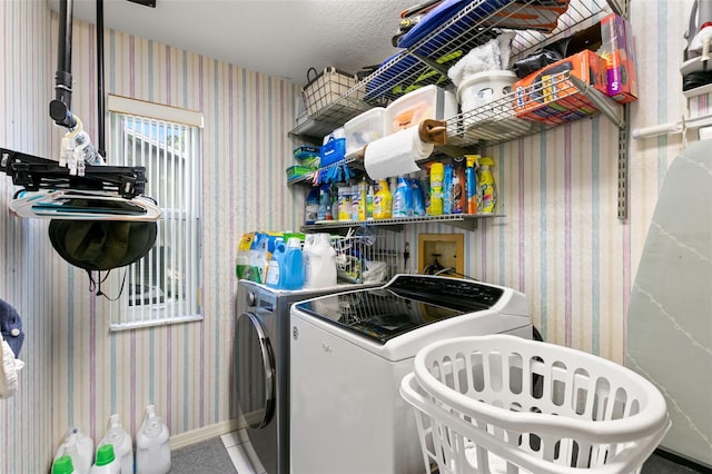 laundry room with independent washer and dryer and a textured ceiling