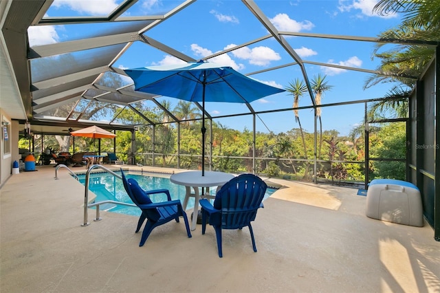 view of swimming pool featuring glass enclosure and a patio area