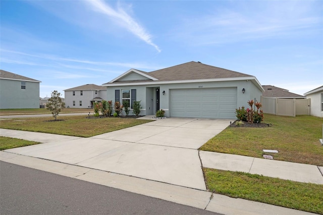 single story home featuring a front lawn and a garage