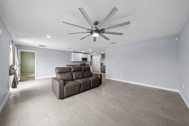 living room featuring ceiling fan and light tile patterned floors