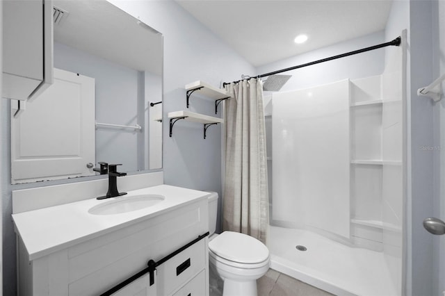 bathroom featuring tile patterned floors, vanity, toilet, and curtained shower